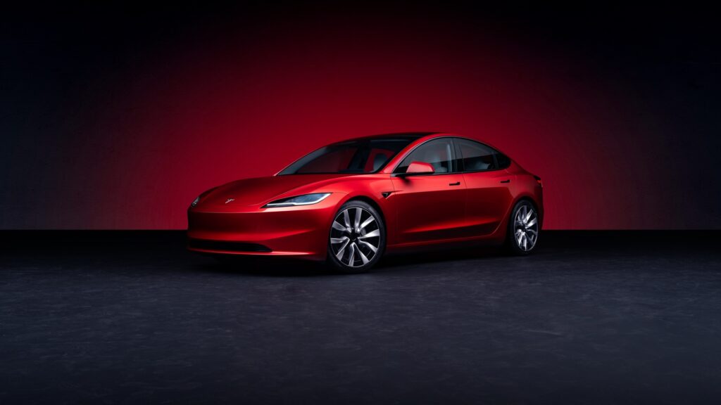 Tesla Model 3 showcased in a sleek red finish, representing innovation and modern technology.